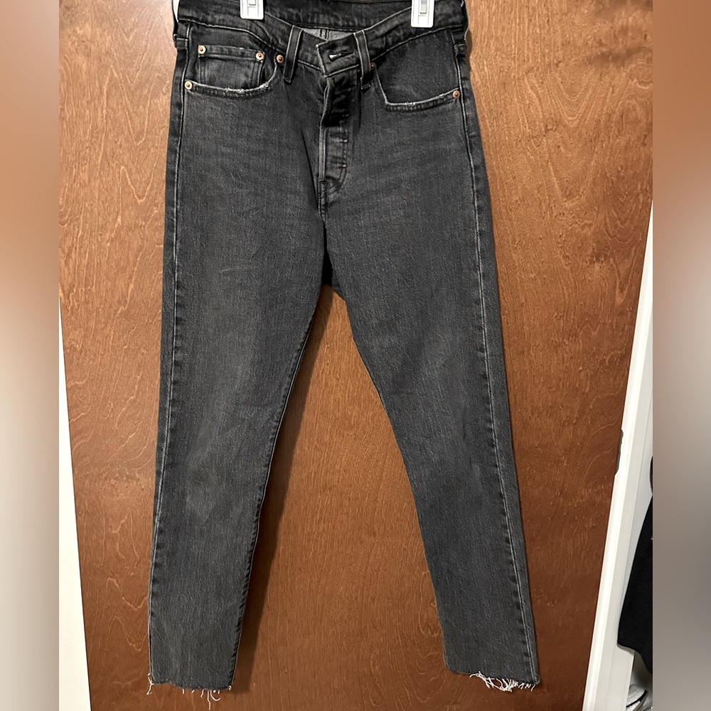 Black denim Levi’s straight leg jeans, button fly, high waist, frayed ankle